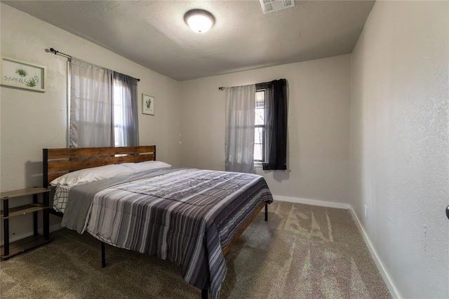 carpeted bedroom featuring a textured ceiling