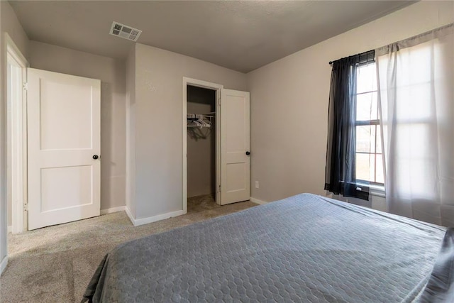 bedroom featuring a closet, carpet floors, and multiple windows