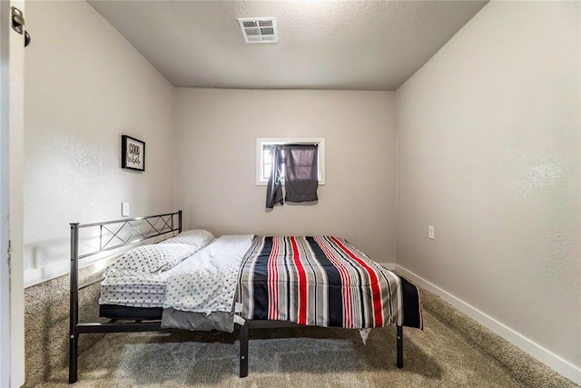 carpeted bedroom featuring a textured ceiling