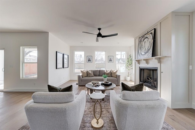 living room featuring ceiling fan and light wood-type flooring