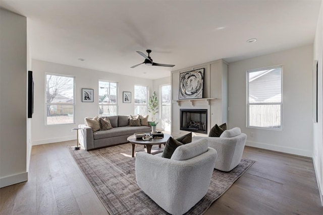 living room with ceiling fan and light hardwood / wood-style flooring