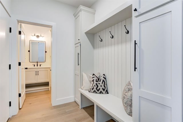 mudroom featuring sink and light hardwood / wood-style floors