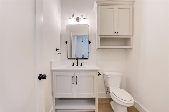 bathroom with vanity, hardwood / wood-style floors, and toilet