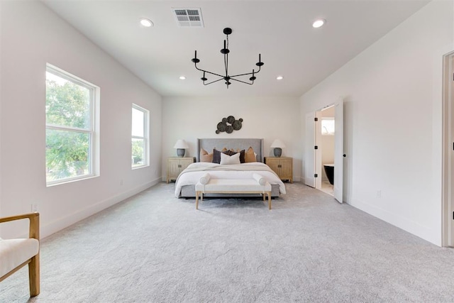 carpeted bedroom with a chandelier