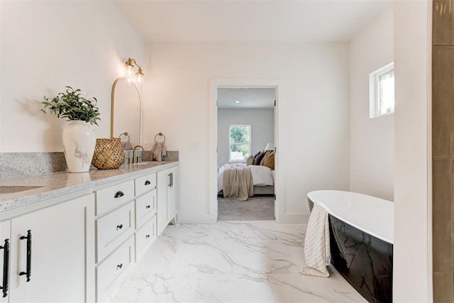 bathroom with vanity and a washtub