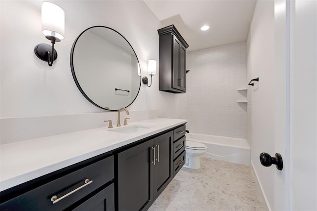 full bathroom with vanity, tiled shower / bath, and toilet