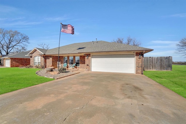 ranch-style home with a front yard and a garage