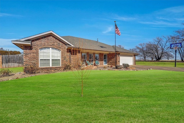 single story home featuring a garage and a front lawn