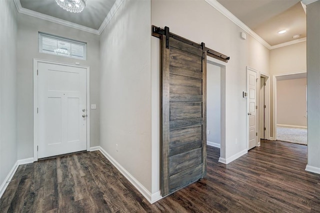 entryway featuring a barn door, dark hardwood / wood-style floors, and ornamental molding