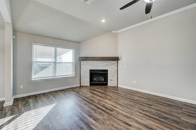 unfurnished living room featuring ceiling fan, a stone fireplace, dark hardwood / wood-style flooring, crown molding, and lofted ceiling