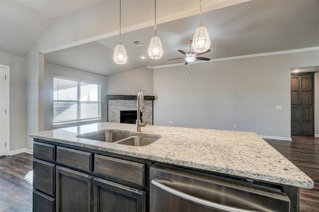 kitchen with vaulted ceiling, ceiling fan, sink, dishwasher, and hanging light fixtures