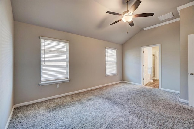 carpeted empty room featuring a wealth of natural light, ceiling fan, and lofted ceiling