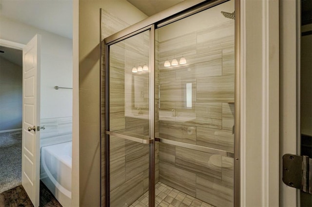 bathroom with shower with separate bathtub