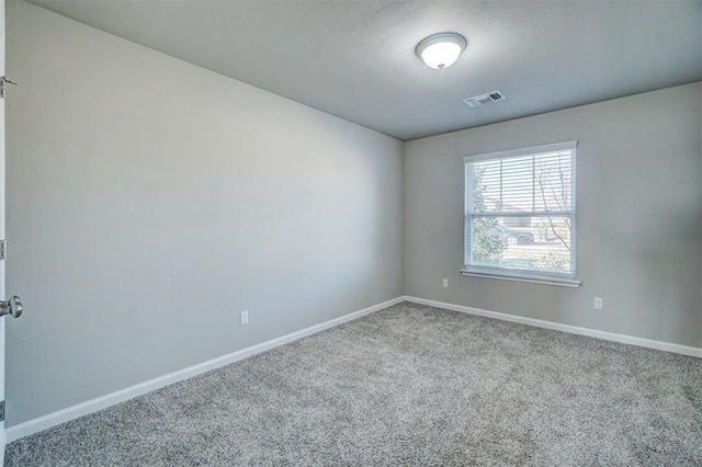 spare room featuring carpet floors