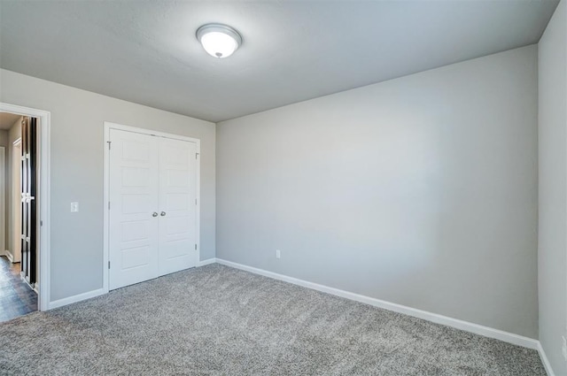 unfurnished bedroom featuring carpet flooring and a closet