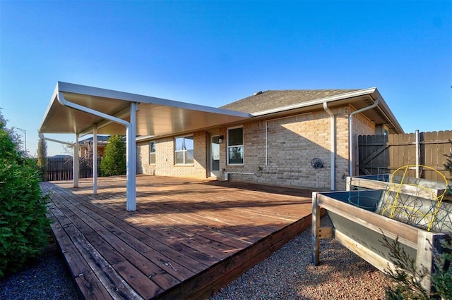 back of house with a wooden deck