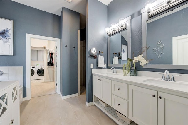 bathroom with vanity, separate washer and dryer, and tile patterned floors