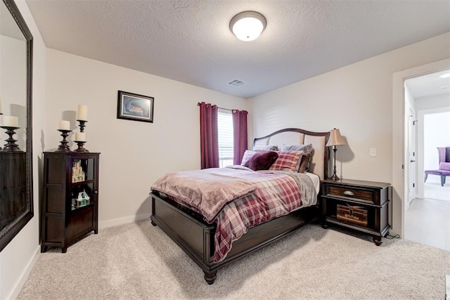 carpeted bedroom with a textured ceiling