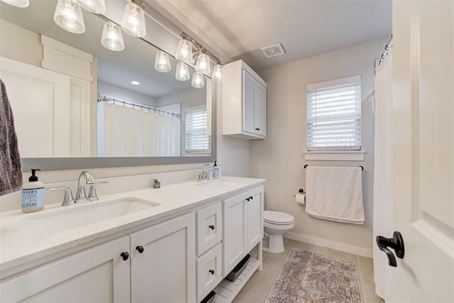 bathroom with tile patterned floors, vanity, and toilet