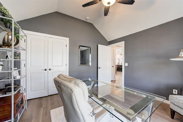 office area with hardwood / wood-style flooring, ceiling fan, and vaulted ceiling