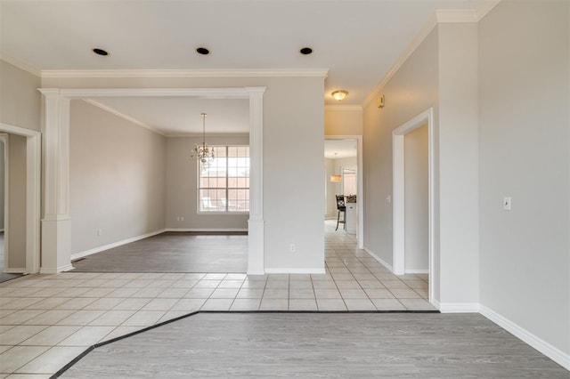 unfurnished dining area featuring ornamental molding, ornate columns, a chandelier, and light tile patterned flooring