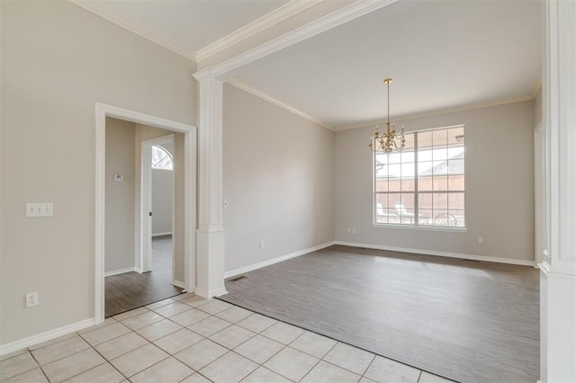 empty room featuring an inviting chandelier, ornamental molding, and light tile patterned floors