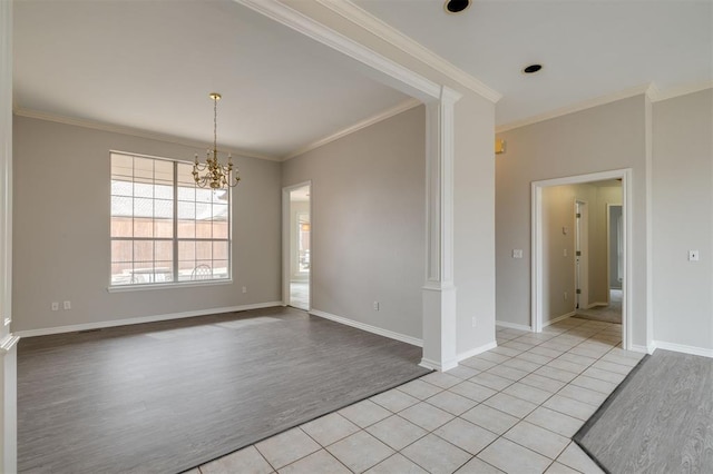 unfurnished room with light tile patterned flooring, ornate columns, ornamental molding, and a notable chandelier