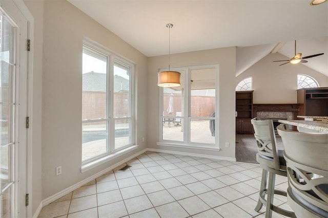 dining room featuring ceiling fan, lofted ceiling with beams, and light tile patterned floors