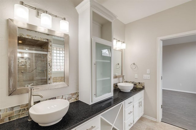 bathroom featuring vanity, tile patterned flooring, and walk in shower