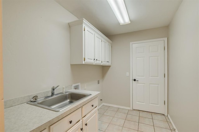 laundry area with cabinets, sink, washer hookup, and light tile patterned floors