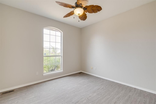 unfurnished room with ceiling fan, a healthy amount of sunlight, and light wood-type flooring