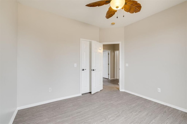 empty room featuring ceiling fan and light wood-type flooring