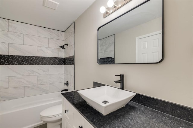 full bathroom featuring vanity, toilet, and tiled shower / bath combo