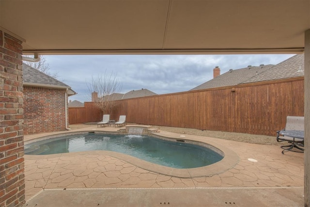 view of pool featuring pool water feature and a patio area