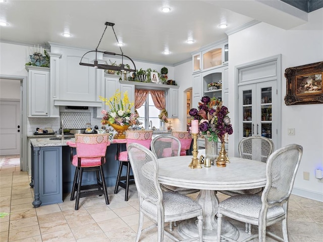 5808 Mistletoe Ct, Oklahoma City, OK 73142 - dining room with french doors, ornamental molding, and sink