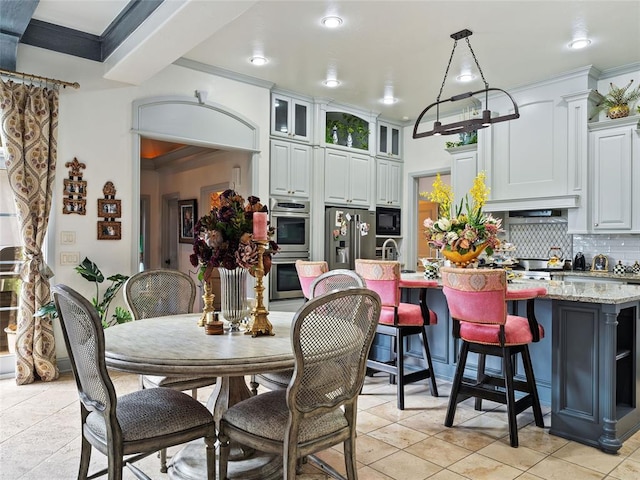 5808 Mistletoe Ct, Oklahoma City, OK 73142 - kitchen with white cabinetry, light stone countertops, decorative backsplash, a center island with sink, and appliances with stainless steel finishes