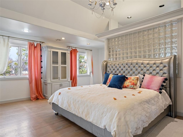 5808 Mistletoe Ct, Oklahoma City, OK 73142 - bedroom with a chandelier, light hardwood / wood-style floors, and vaulted ceiling