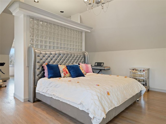 5808 Mistletoe Ct, Oklahoma City, OK 73142 - bedroom with light hardwood / wood-style flooring, lofted ceiling, and an inviting chandelier