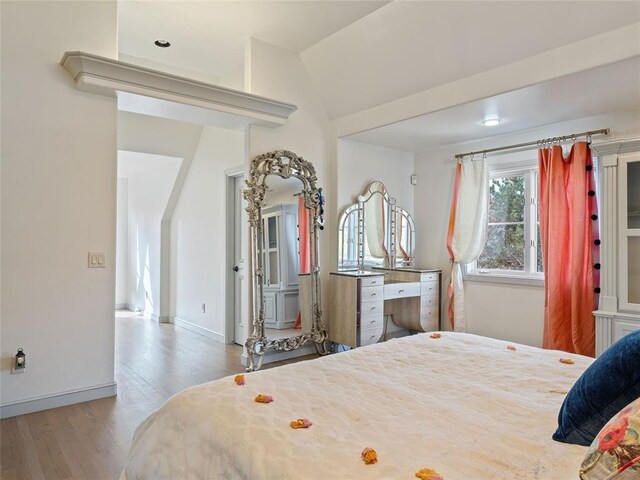 5808 Mistletoe Ct, Oklahoma City, OK 73142 - bedroom featuring hardwood / wood-style flooring and vaulted ceiling