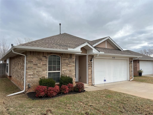 ranch-style home featuring a garage and a front lawn