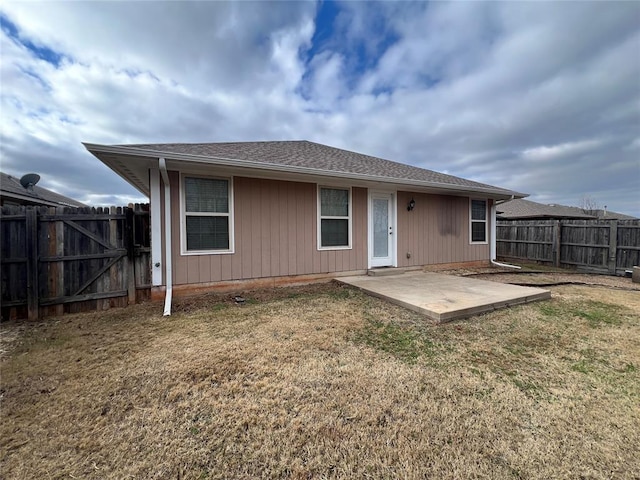 back of house with a yard and a patio area