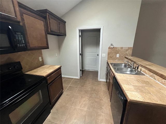 kitchen featuring tasteful backsplash, sink, black appliances, and vaulted ceiling