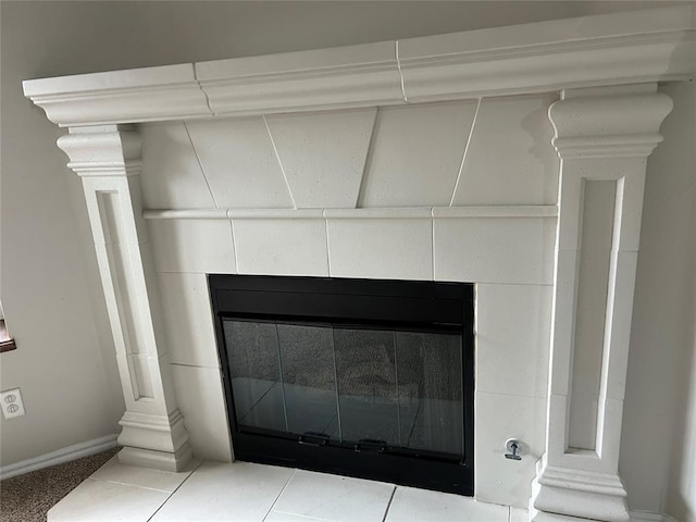 room details featuring a tiled fireplace