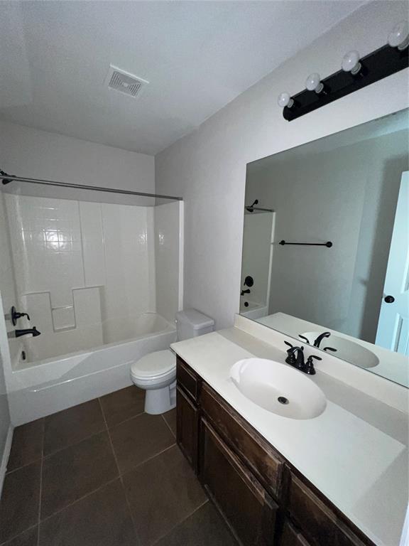 full bathroom with tile patterned flooring, vanity, toilet, and shower / bath combination