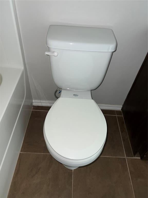 bathroom with tile patterned flooring and toilet