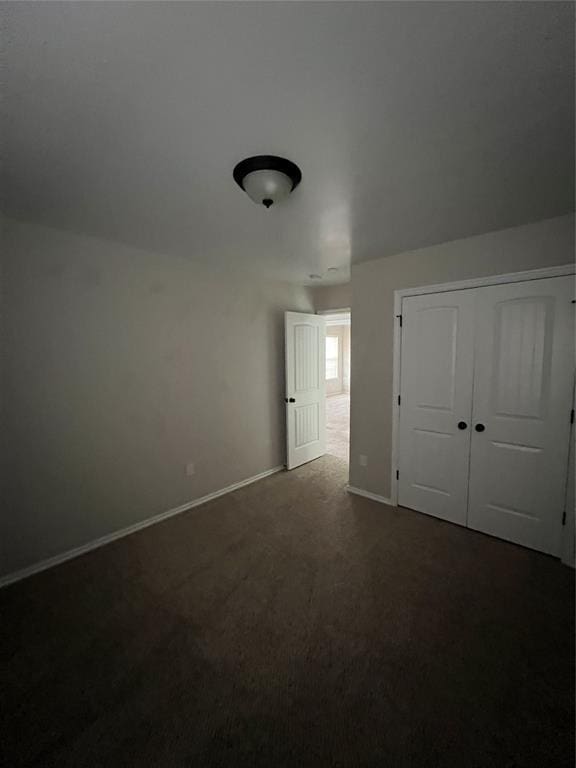 bonus room featuring dark carpet