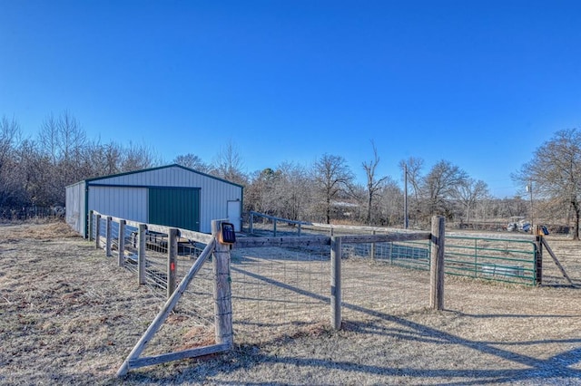 view of yard with a rural view and an outbuilding