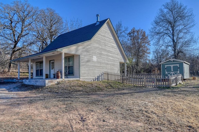 exterior space featuring covered porch and a storage unit