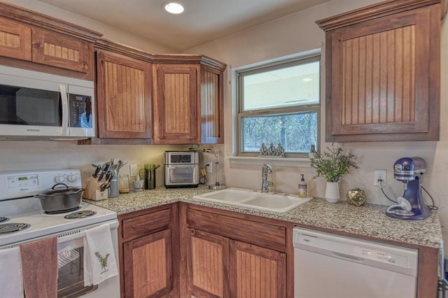 kitchen featuring sink and white appliances