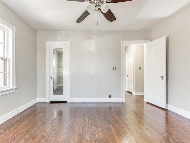 spare room with ceiling fan and dark hardwood / wood-style floors